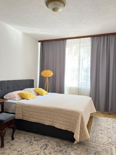 a bedroom with a large bed and a window at Guest House Bosnian House in Sarajevo