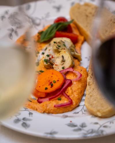 a plate with a sandwich with vegetables and bread at Grand Hôtel d'Orléans in Toulouse