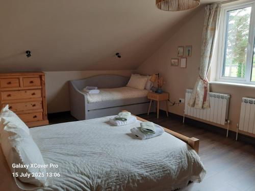 a bedroom with a bed with towels on it at The Rebel Yew in Killala