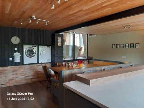 a kitchen with a washer and dryer in a house at The Rebel Yew in Killala