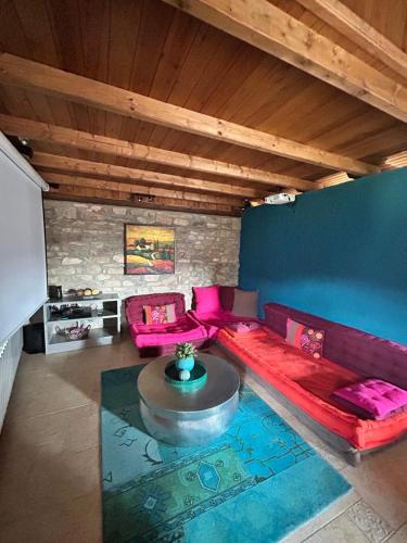 a living room with a red couch and a table at Casa del Castell de Toloriu in Toloríu