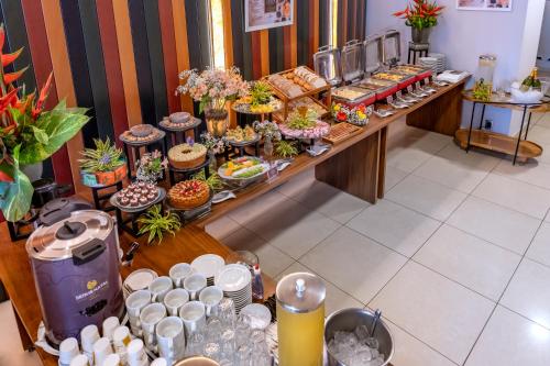 a buffet line with many different types of food at SERHS Experience Suítes in Natal