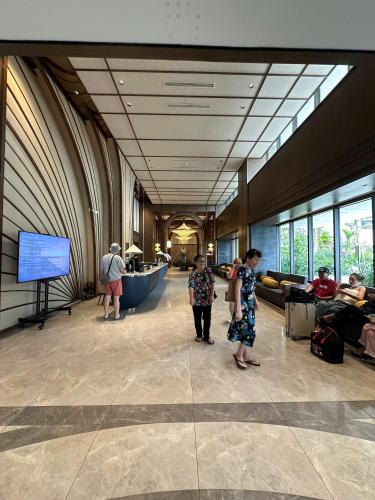 a group of people standing in a lobby at Apec Mandala wyndham Apartment - APEC Mui Ne in Mui Ne