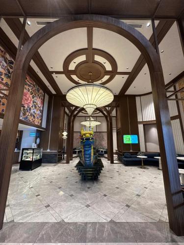 a large lobby with a large chandelier in a building at Apec Mandala wyndham Apartment - APEC Mui Ne in Mui Ne