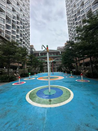 a fountain in the middle of a city with tall buildings at Apec Mandala wyndham Apartment - APEC Mui Ne in Mui Ne