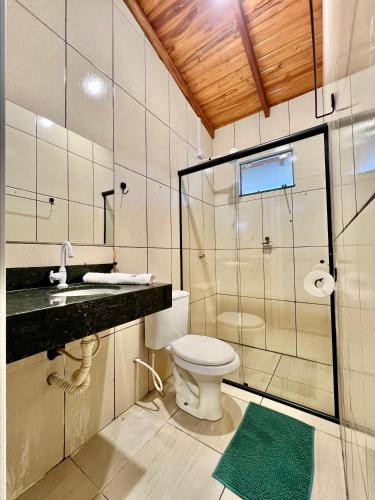 a bathroom with a toilet and a glass shower at Casa do Cerrado in Ribas do Rio Pardo