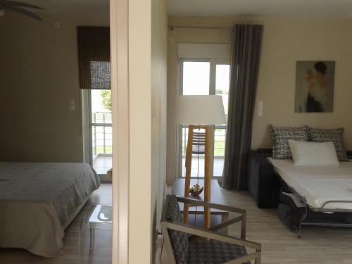a bedroom with a bed and a table and a chair at Marion Apartments in Kourouta