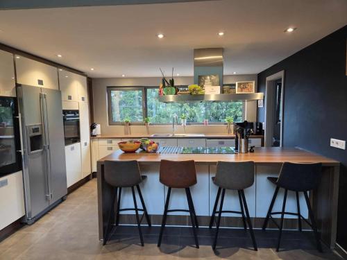 a kitchen with a island with bar stools at La Clé du Circuit Spa-Francorchamps in Stavelot