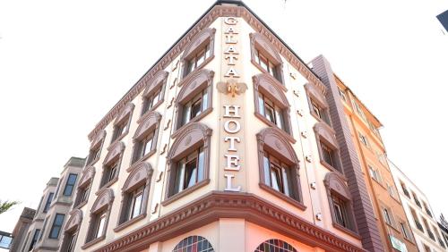 a building with a sign on the side of it at Galata Fil Hotel in Istanbul