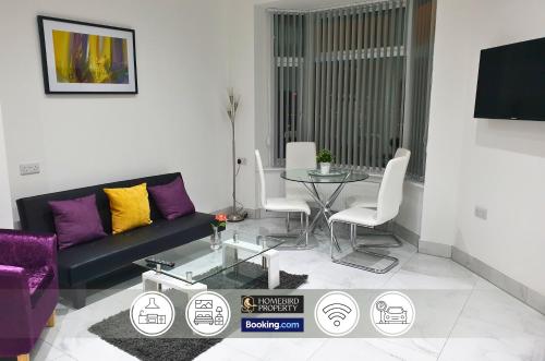 a living room with a couch and a table at Spacious 3-Bedroom House Near Leeds City Centre By Homebird Property Management Short Lets & Serviced Accommodation Leeds With En-Suite Bathrooms & Free Parking in Leeds