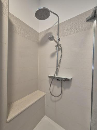 a shower with a glass door in a bathroom at Seaview Art Studio with balcony in Kaštela