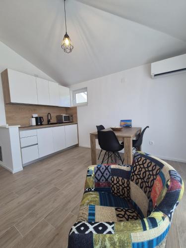 a living room with a couch and a table at Seaview Art Studio with balcony in Kaštela
