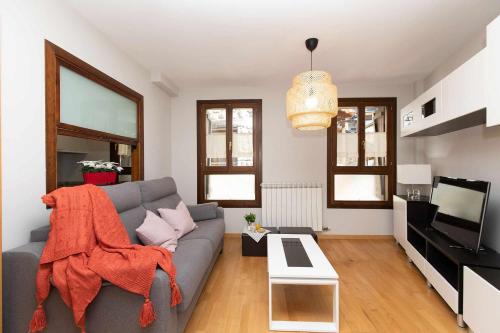 a living room with a couch and a tv at Casa de La Laguna by BeValle in Panticosa