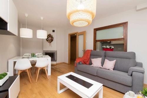 a living room with a couch and a table at Casa de La Laguna by BeValle in Panticosa