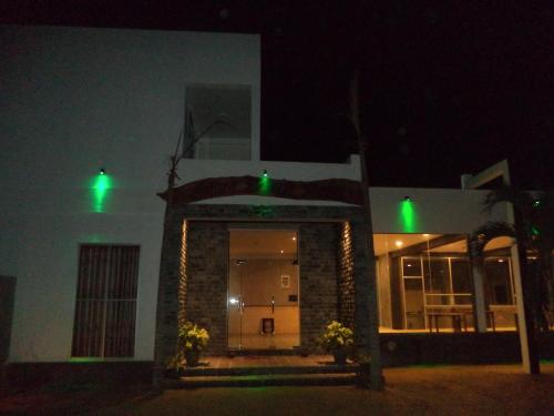 a building with green lights in the dark at Saara Beach Hotel in Marawila