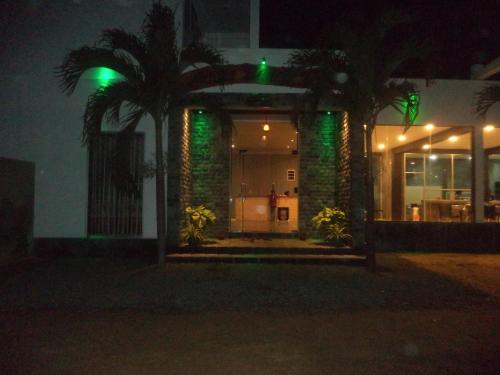 a building with green lights on it at night at Saara Beach Hotel in Marawila