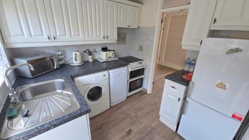 een keuken met een witte koelkast en een vaatwasser bij Herne Bay - House - Sleeps 7 - Parking in Herne Bay