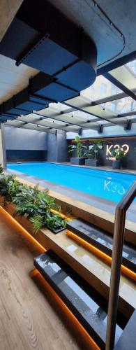 a swimming pool with potted plants on the stairs at Luxury River Side apartament, Pool, Gym & Sauna in Kraków