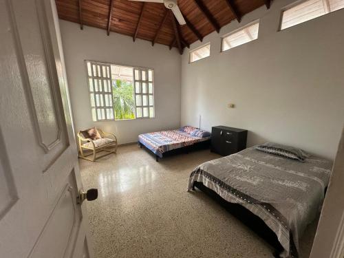 a bedroom with a bed and a couch in it at Casa campestre con piscina, jacuzzi y bbq in La Dorada