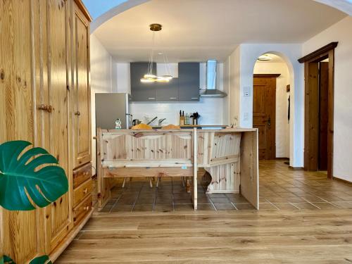 a kitchen with wooden cabinets and a counter top at Ferienwohnungen Hotel Bellevue in Seelisberg