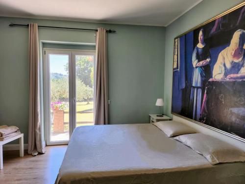 a bedroom with a large painting on the wall at SabinaCountrySide in Corese Terra
