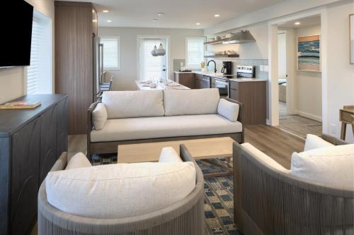 a living room with a couch and a table at Oceaneer Hotel in Carolina Beach
