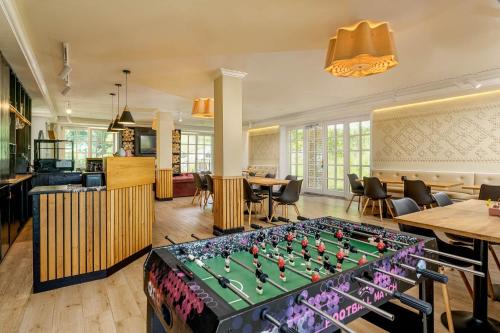 a room with a foosball table in the middle at The Lodge Transylvania in Bran
