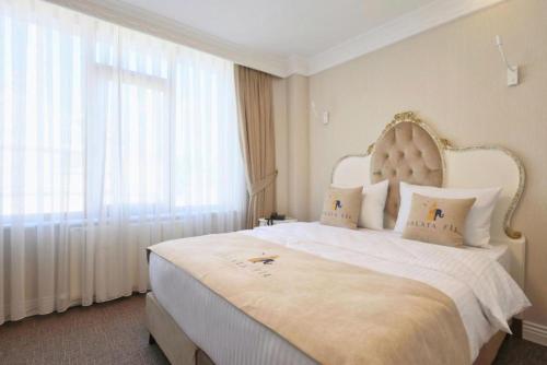 a bedroom with a large bed with a large window at Galata Fil Hotel in Istanbul