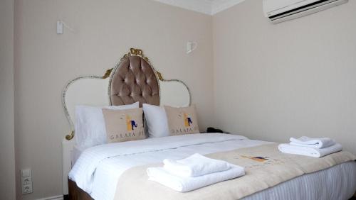 a bedroom with a bed with white towels on it at Galata Fil Hotel in Istanbul