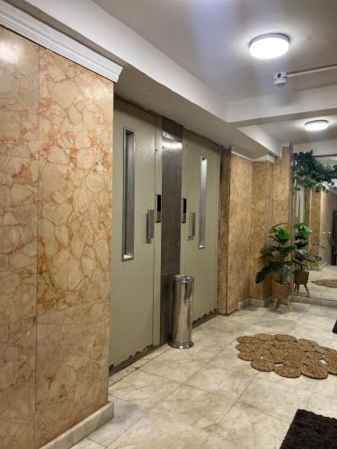 a lobby with a walk in shower in a building at Houres Hotel in Cairo