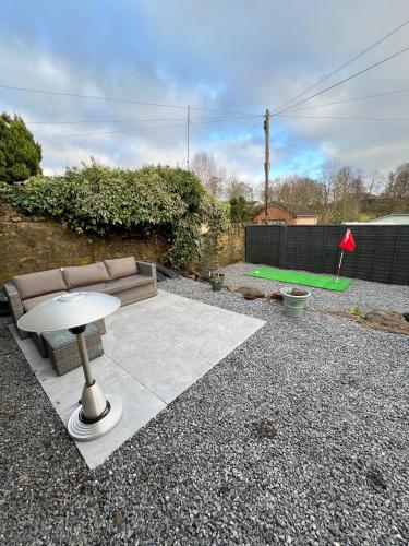 a patio with a couch and a table in a yard at Spacious 2 bed traditional cottage in Crieff