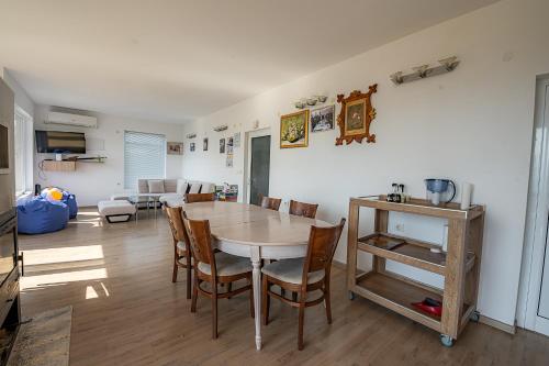 a kitchen and dining room with a table and chairs at AMAZING view, privacy and comfort - SPA Villa Krasi in Blagoevgrad