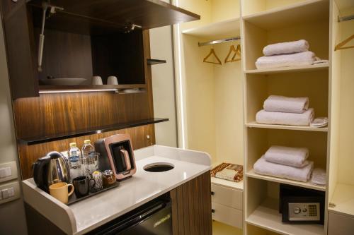 a small kitchen with a counter and towels at Munir`s residence 3 in Cairo