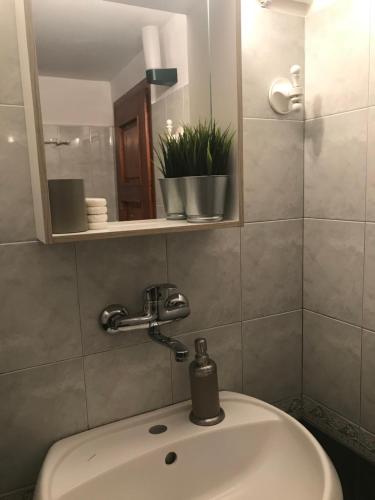 a bathroom with a sink and a mirror at Tipografov View Guest House in Veliko Tŭrnovo