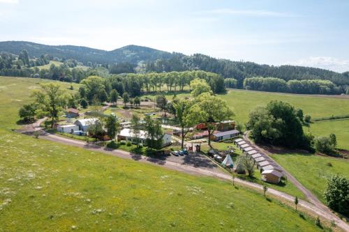 an aerial view of a farm in a field at Teepee a karavanové stání Koupálo Janovičky in Heřmánkovice