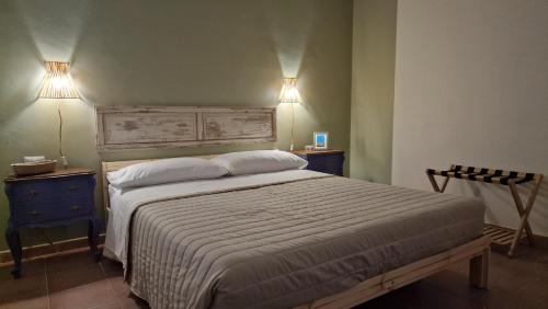 a bedroom with a bed with two lights on the wall at Le case di Papà Nuccio in Pietrabbondante