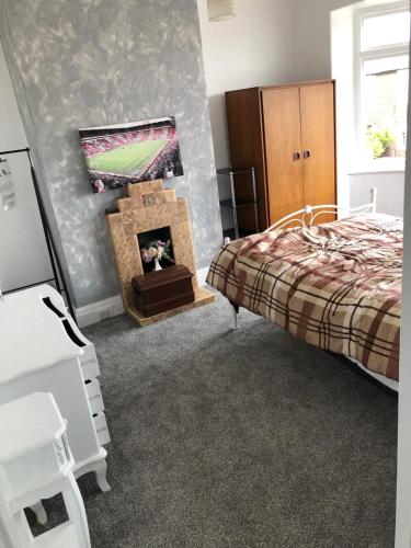a bedroom with a bed and a dog in a fireplace at Retro Premiership Stadium of Light Eco Stopover in Monkwearmouth