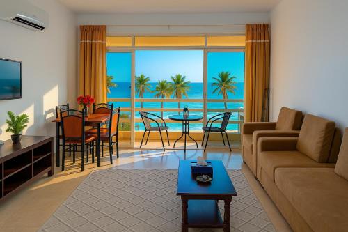 a living room with a couch and a table at Beautiful Salalah Beach Apartments - 1 by Beautiful Salalah Tours in Salalah