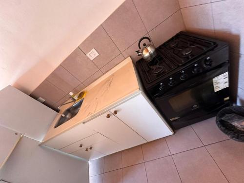 Kuchyň nebo kuchyňský kout v ubytování Condominio Atuel con Cocina Wifi Cochera Desayuno