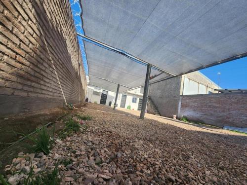 a building with a covering on the side of it at Condominio Atuel con Cocina Wifi Cochera Desayuno in San Rafael