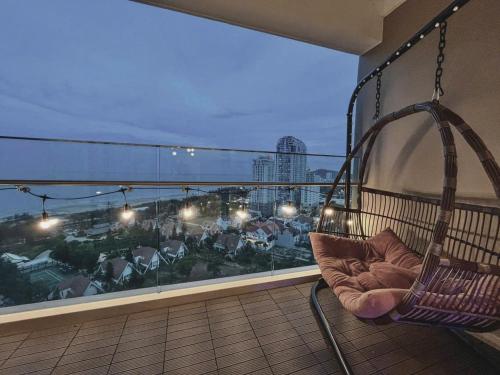 a swing on a balcony with a view of a city at Sóng Homestay-The Sóng Apartment Vũng Tàu Nghỉ Dưỡng Biển Cao Cấp 5 Sao- The Song Vung Tau Condotel 5 Star Beach View Apartment in Vung Tau