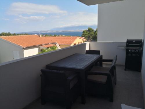 a black table and chairs on a balcony with a view at Júlia in Vir