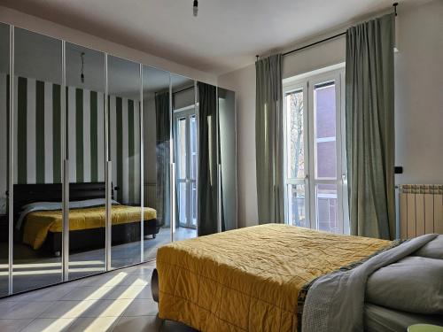 a bedroom with two beds and a large mirror at Appartamento Milanino in Cusano Milanino