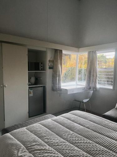 a bedroom with a bed and a window at Peaamb GuestHouse - Springs Golf Club in Springs