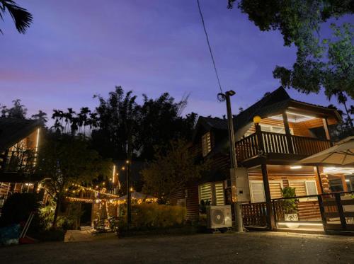 a house with christmas lights in front of it at 郭媽媽包棟小木屋民宿 in Gukeng