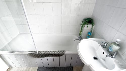 a bathroom with a toilet and a sink at Family friendly 3-bed home free parking on site in Huddersfield