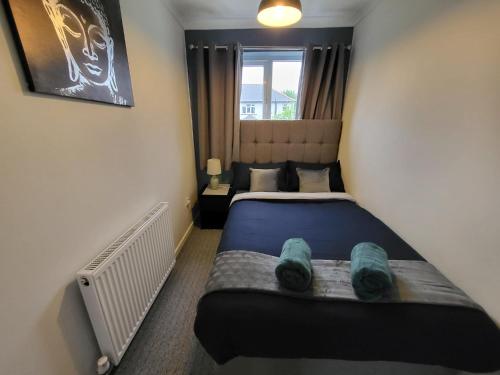 a bedroom with a bed in a room at Family friendly 3-bed home free parking on site in Huddersfield