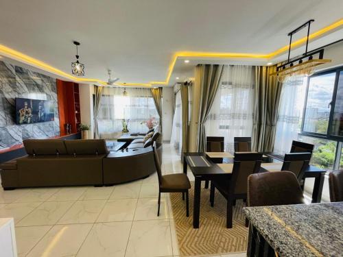 a living room with a couch and a table at Mambo Sea view 3bd Penthouse Mombasa in Mombasa