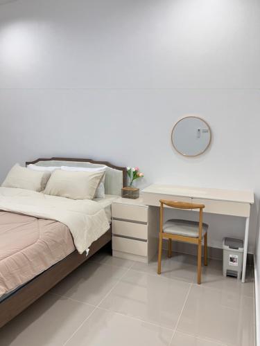 a bedroom with a desk and a bed with a chair at The Stay Inn in Kampong Rusamileh
