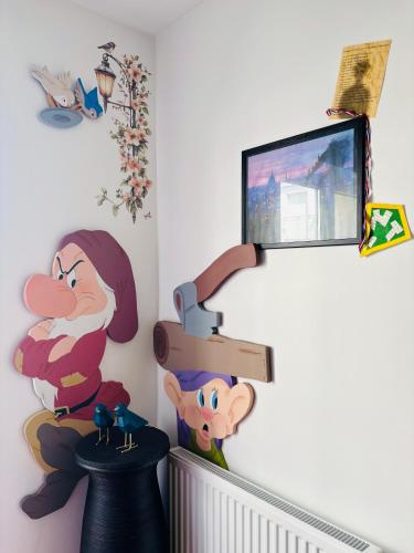 a childs room with a disney cartoon on the wall at THE ENCHANTED HOUSE ( 15 min walk to Disney) in Serris